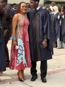 Graduation ceremony with attendees in gowns.